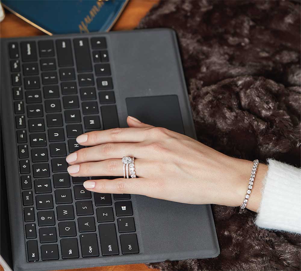 Women Wearing Lab Grown Diamond Rings and Bracelet Typing